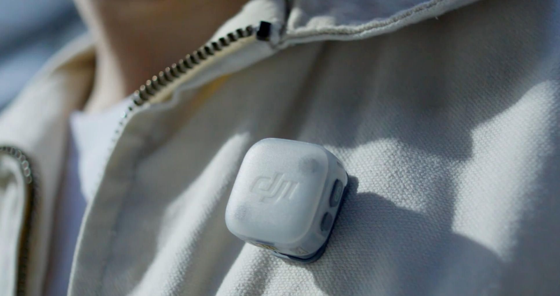 DJI Mic Mini 2 transmitter clipped to a creator's jacket